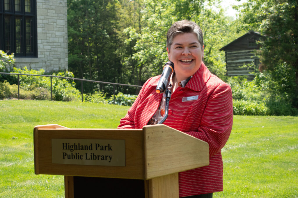 Executive Director Heidi Smith speaks at the podium.