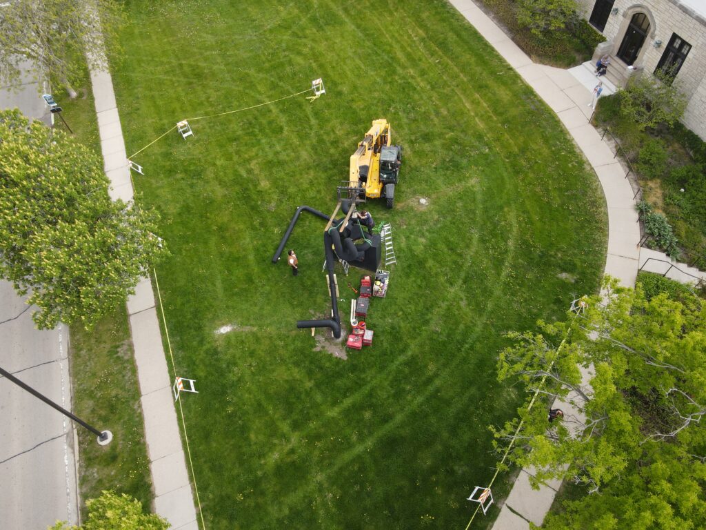 Overhead view of workers dismantling the Miss Nitro sculpture.