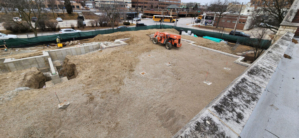 High, wide angle view of the completed footings which form the perimeter of the new expansion.