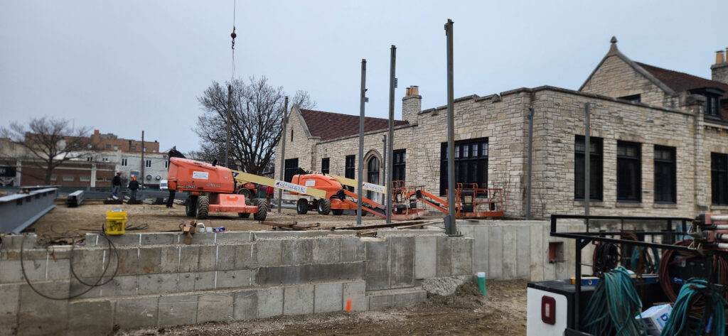 Wide view of the new footings with three tall steel pillars erected.